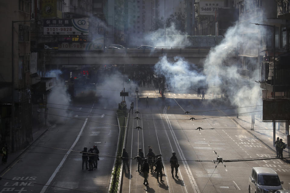 Police officers fire tear gas at demonstrators during a protest in Hong Kong, Saturday, Nov. 2, 2019. Defying a police ban, thousands of black-clad masked protesters are streaming into Hong Kong's central shopping district for another rally demanding autonomy in the Chinese territory as Beijing indicated it could tighten its grip. (AP Photo/Kin Cheung)