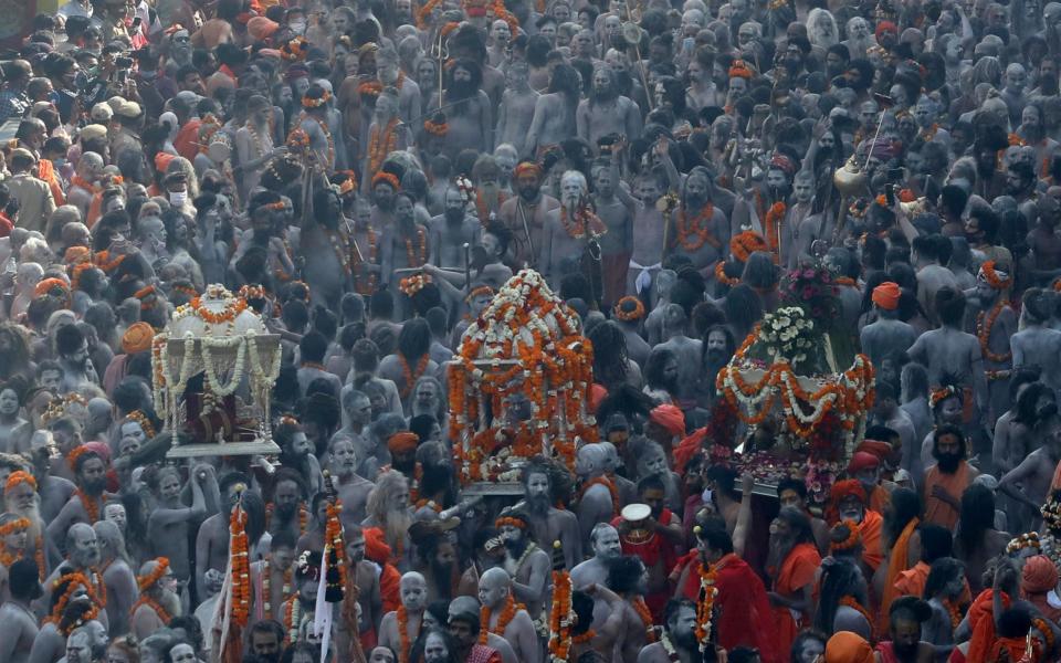 Naga Sadhus, or Hindu holy men participate in a procession to take a dip in the Ganges river during Shahi Snan at "Kumbh Mela", or the Pitcher Festival, amidst the spread of the coronavirus disease (COVID-19), in Haridwar, India - ANUSHREE FADNAVIS / REUTERS