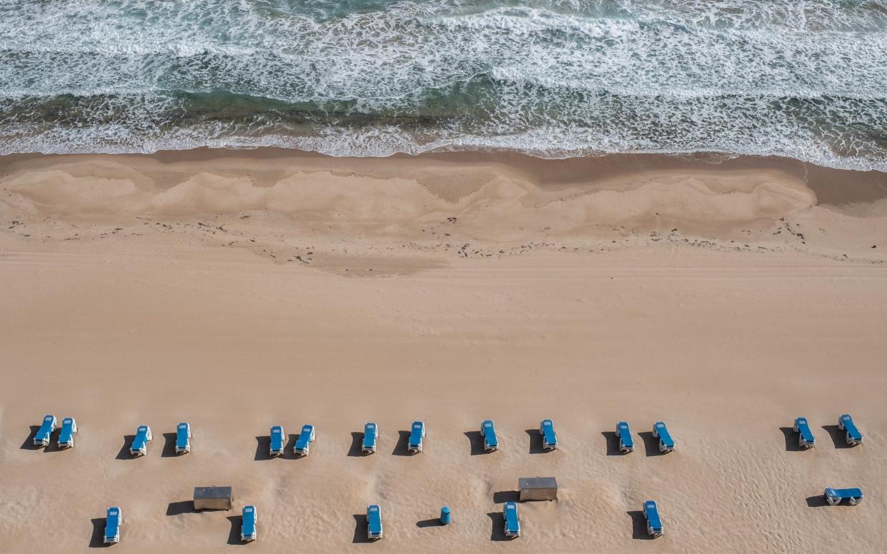 Sun loungers on the sand at the closed Playa de Levante Beach in Benidorm. There are plans in resorts to segregate bathers in order to keep different groups at risk from Covid-19 apart - David Ramos/Getty Images