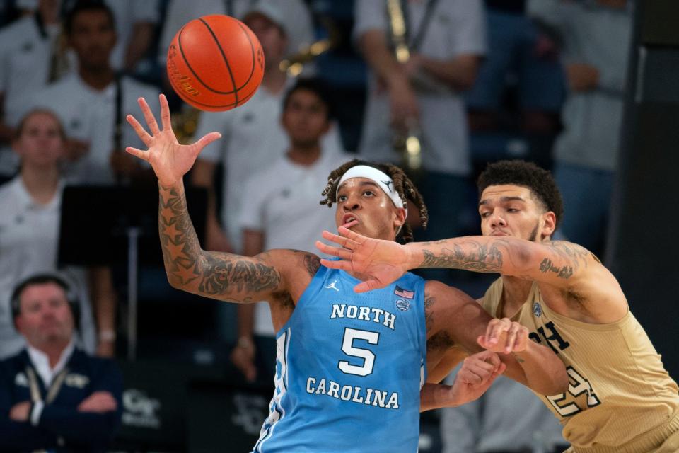 North Carolina forward Armando Bacot, left, works for position in the post against Georgia Tech center Rodney Howard during Sunday’s game at McCamish Pavilion.