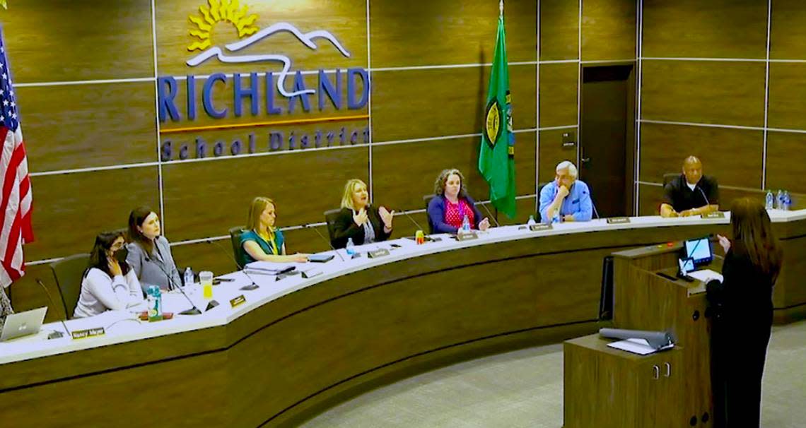 Board president Jill Oldson, middle at left, temporarily moves the April 26, 2022 Richland School Board meeting into recess after hecklers argued over the new public comment period. 