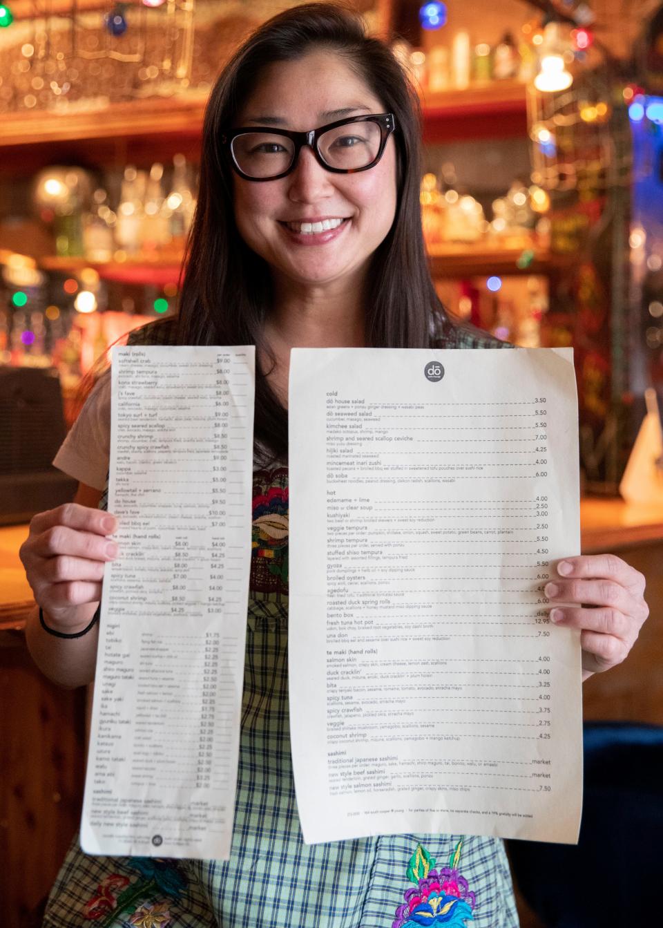Mindy Son holds the Dō Sushi original menus Friday, March 11, 2022, at Bar DKDC in Memphis. Dō Sushi will host a one day pop-up at the bar on Wednesday, March 23. The general manager, Son will help roll sushi during the pop-up.