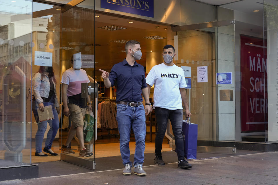 U.S. Army veteran Spencer Sullivan, left, and Abdulhaq Sodais, who served as his translator in Afghanistan, walk out of a clothing shop after Sullivan bought a suit for Abdulhaq in Bremen, Germany, Saturday, Aug. 14, 2021. Sullivan flew from California to Germany to help Sodais pick out something to wear for his Sept. 6 asylum hearing. (AP Photo/Peter Dejong)