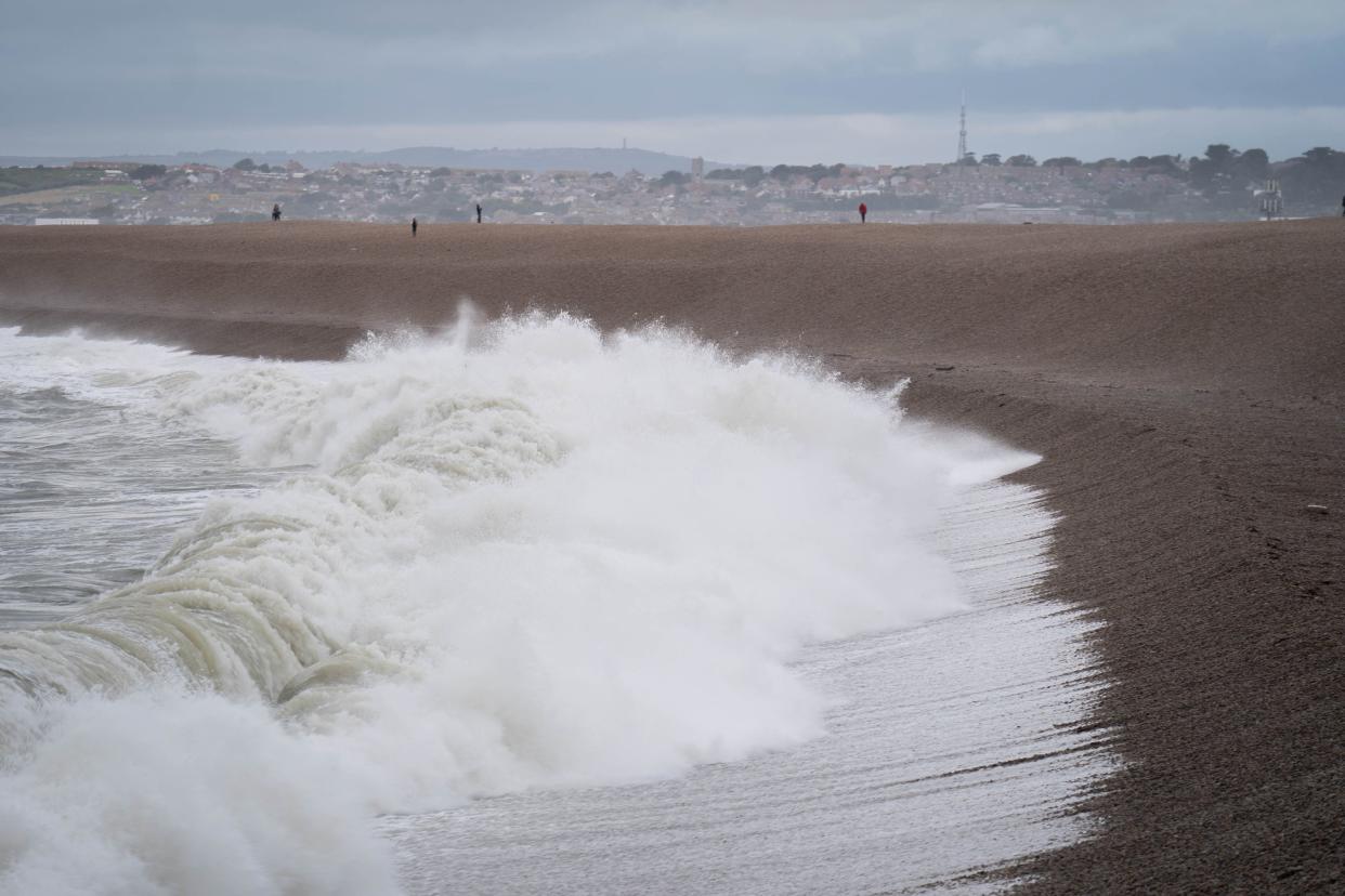 Waves crash against Chiswell Beach in Dorset, Wednesday 2 August (PA)