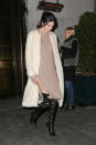 <p>Jenner’s lengthy gams peeked out between her high-slit sweater dress and over-the-knee black boots. </p>