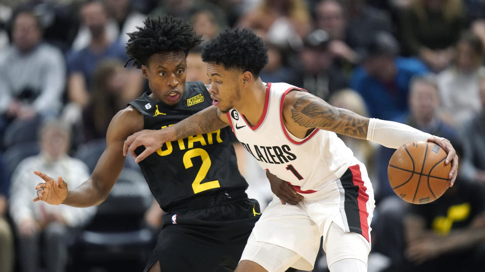 Utah Jazz guard Collin Sexton (2) defends against Portland Trail Blazers guard Anfernee Simons (1) during the second half of an NBA basketball game Saturday, Dec. 3, 2022, in Salt Lake City. (AP Photo/Rick Bowmer)