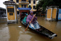 Officials sail a boat out of a submerged local government building after typhoon Damrey hits Vietnam in Hue city, Vietnam November 5, 2017. REUTERS/Kham