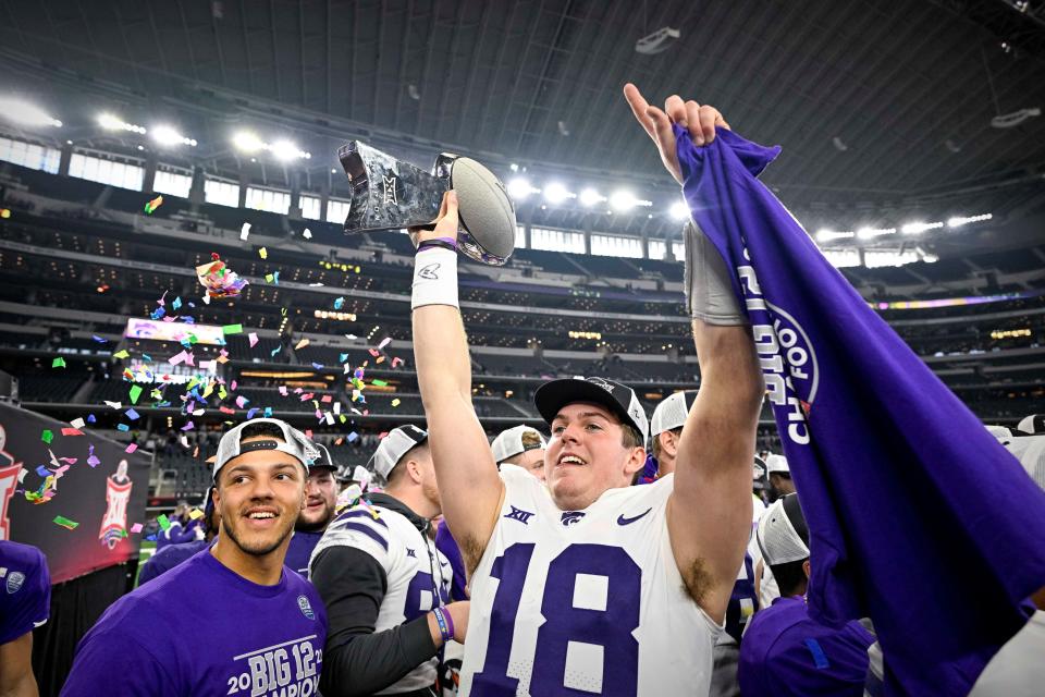 Dec 3, 2022; Arlington, TX, USA; Kansas State Wildcats quarterback Will Howard (18) holds up the championship trophy as the Wildcats celebrate winning the Big 12 championship after defeating the TCU Horned Frogs overtime at AT&T Stadium. Mandatory Credit: Jerome Miron-USA TODAY Sports