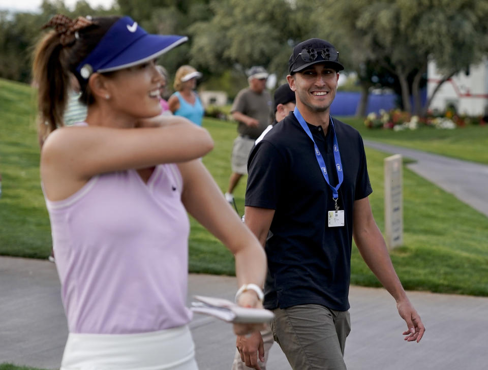 FILE - In this April 4, 2019, file photo, Michelle Wie, left, walks off the ninth green with Jonnie West during the first round of the LPGA Tour ANA Inspiration golf tournament at Mission Hills Country Club in Rancho Mirage, Calif. New mom Wie West is looking forward to being nervous again on the golf course. It's been nearly two years since Wie West last played a competitive round on the LPGA Tour, and nine months since she gave birth to daughter Makenna. (AP Photo/Chris Carlson, File)