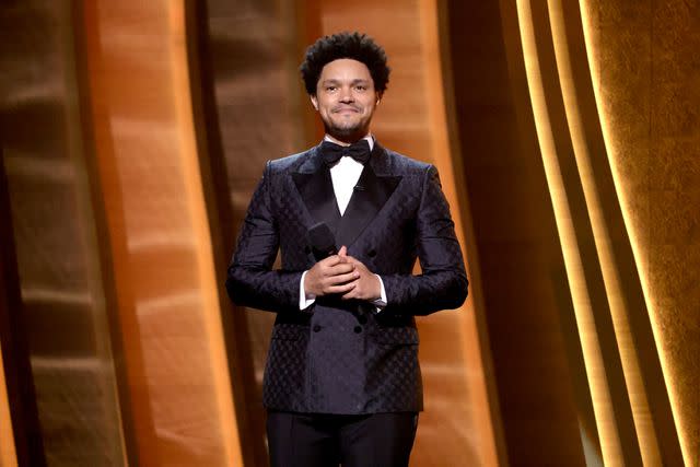 <p>Emma McIntyre/Getty</p> Trevor Noah speaks onstage during the 64th Annual GRAMMY Awards at MGM Grand Garden Arena on April 03, 2022 in Las Vegas