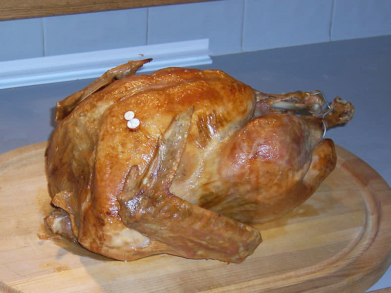 If your turkey has a "pop-up" temperature indicator, it is recommended that you also check the internal temperature of the turkey in the innermost part of the thigh and wing and the thickest part of the breast with a food thermometer. The minimum internal temperature should reach 165&deg;F for safety.