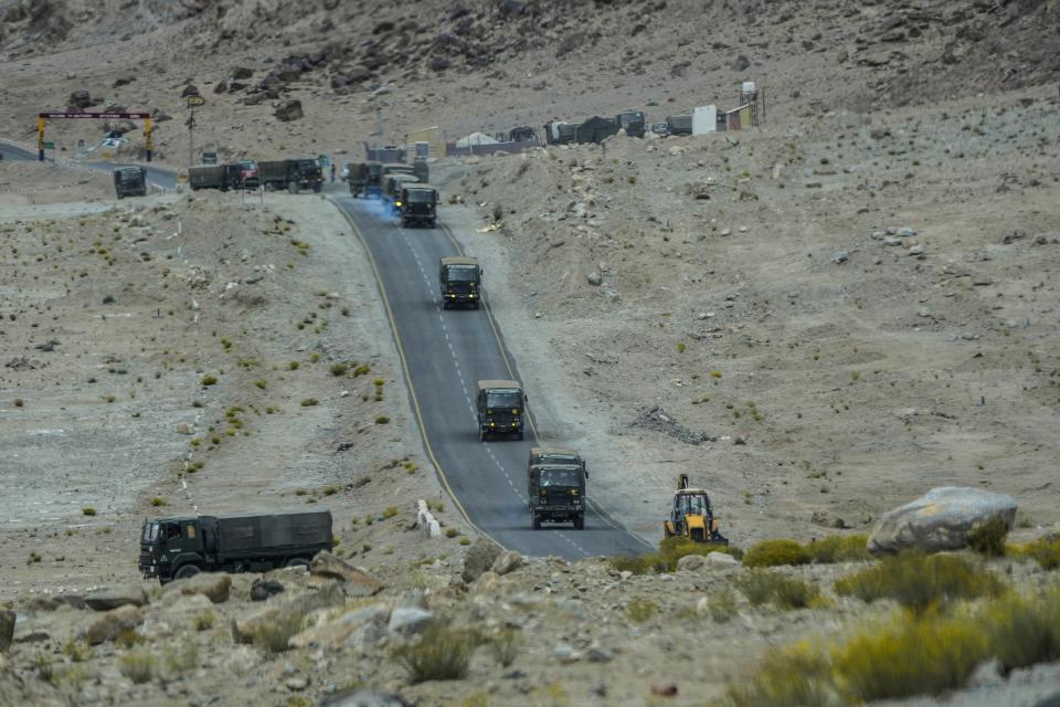 Indian army vehicles move in a convoy in the cold desert region of Ladakh, India, Tuesday, Sept. 20, 2022. Nestled between India, Pakistan and China, Ladakh has not just faced territorial disputes but also stark climate change. (AP Photo/Mukhtar Khan)