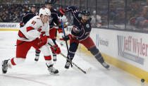 Carolina Hurricanes' Jake Gardiner, left, and Columbus Blue Jackets' Nick Foligno chase the puck during the second period of an NHL hockey game Thursday, Jan. 16, 2020, in Columbus, Ohio. (AP Photo/Jay LaPrete)