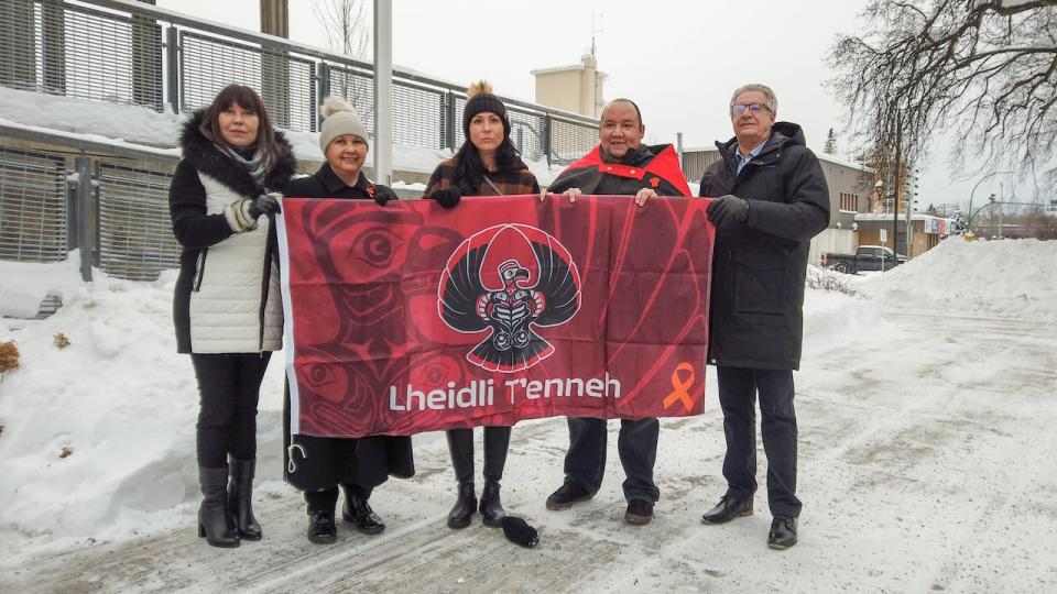 From left to right, Lheidli T'enneh Chief Dolleen Logan, elder Darlene McIntosh, Coun. Crystal Gibbs, Coun. Joshua Seymour, and Prince George Mayor Lyn Hall hold the First Nation's new flag together before it was raised to full-mast at a ceremony at the city hall on Jan. 4.