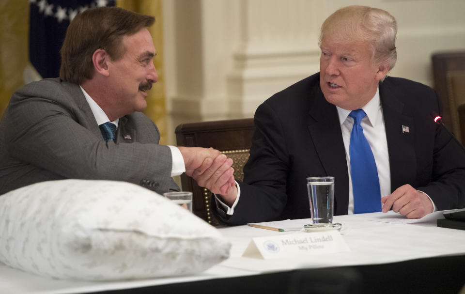 US President Donald Trump shakes hands with Mike Lindell (L), founder of My Pillow, during a Made in America event with US manufacturers in the East Room of the White House in Washington, DC, July 19, 2017. / AFP PHOTO / SAUL LOEB        (Photo credit should read SAUL LOEB/AFP via Getty Images)