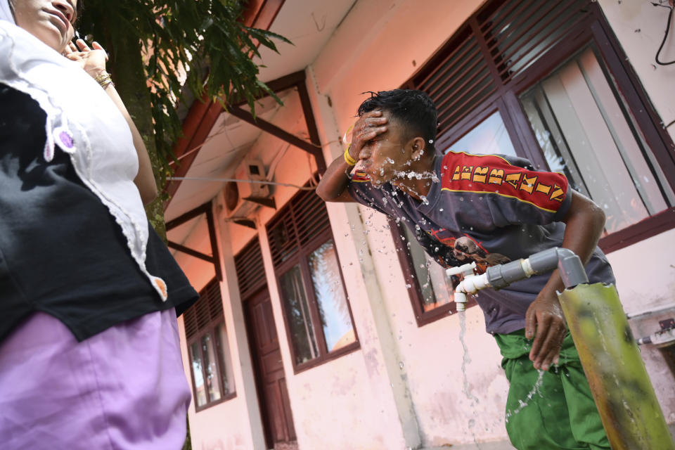 Jannat Ullah, a Rohingya survivor of a capsized refugee boat, washes his face at a temporary shelter in Meulaboh, Indonesia, on Thursday, April 4, 2024. Jannat was among 75 people rescued from atop the overturned hull of the boat, which capsized off Indonesia's coast in March. Dozens of others died. (AP Photo/Reza Saifullah)