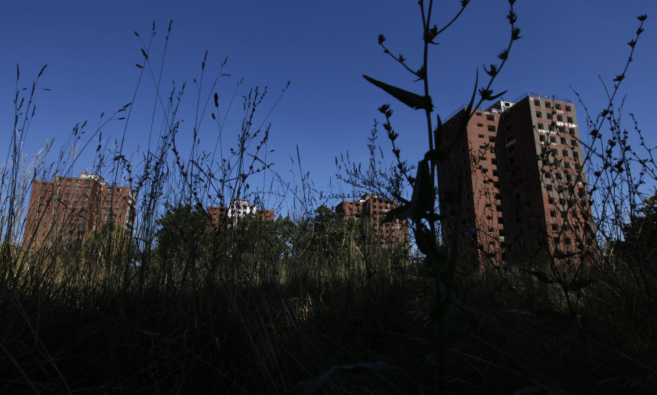 The Frederick Douglass Homes are shown through overgrown grass in Detroit, Wednesday, Sept. 4, 2013. The graffiti-covered complex comprising several city blocks is better known as the Brewster projects. A $6.5 million emergency federal grant covers the initial phase of demolition and cleanup, and officials say the city will be eligible for more money when that’s completed. The federal money comes at a crucial time for the city, which is overseen by a state-appointed emergency manager and in July became the nation’s largest city to file for bankruptcy.(AP Photo/Paul Sancya)