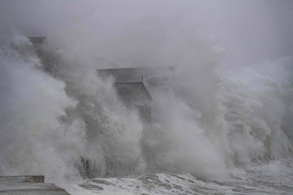 Waves crash over oceanfront homes during a noreaster in Scituate, Massachusetts, on January 29, 2022. Climate change is making storms more powerful compounding coastal issues of sea-level rise and erosion (AFP via Getty Images)