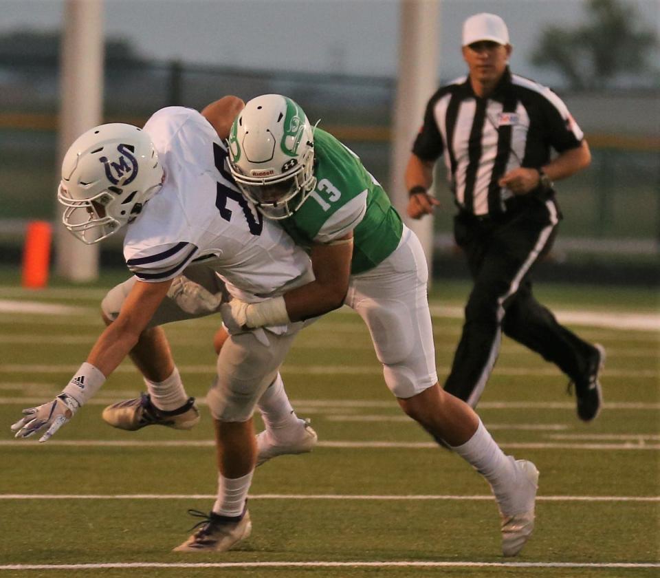 Mason High School's Tate Spencer is tackled by Wall's Taven Espinosa during a nondistrict football game at Hawk Stadium on Friday, Sept. 18, 2020.