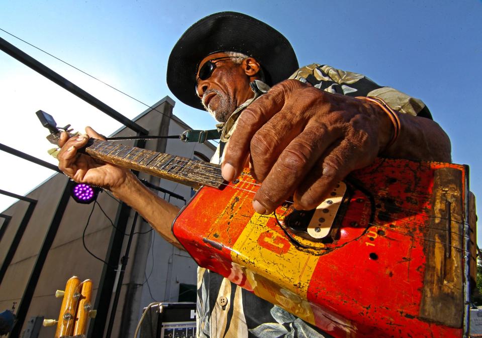 Mac Arnold plays on his homemade gas can guitar at the Piedmont Natural Gas Block Party at Carolina Wren Park in Anderson Thursday, May 22, 2014.