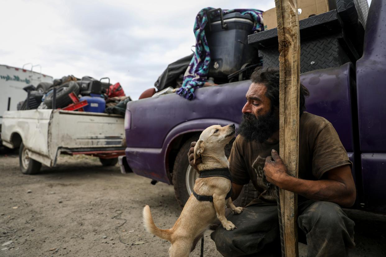 Nick Felton and his dog Xena prepare Aug. 17, 2021, to move out of a homeless community in Salem's Cascades Gateway Park.