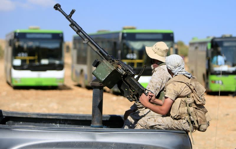 FILE PHOTO: Hezbollah fighters sit on a back of a truck mounted with an anti-aircraft weapon in Jroud Arsal, near Syria-Lebanon border