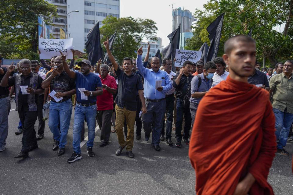 Trade union and civil society activists led by leftists' People Liberation Front shout slogans denouncing president Ranil Wickremesinghe as they march in streets in Colombo, Sri Lanka, Tuesday, Aug. 9, 2022. Hundreds of Sri Lankans Tuesday rallied against a government crackdown and the use of emergency laws against those who protested peacefully against the country’s worst economic crisis in recent memory. (AP Photo/Eranga Jayawardena)