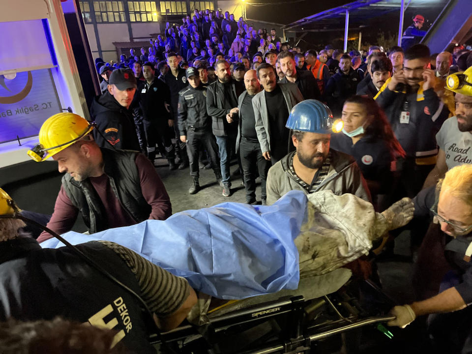 Miners carry the body of a victim in Amasra, in the Black Sea coastal province of Bartin, Turkey, Friday, Oct. 14, 2022. An official says an explosion inside a coal mine in northern Turkey has trapped dozens of miners. At least 14 have come out alive. The cause of Friday's blast in the town of Amasra in the Black Sea coastal province of Bartin was not immediately known. (Nilay Meryem Comlek/Depo Photos via AP)