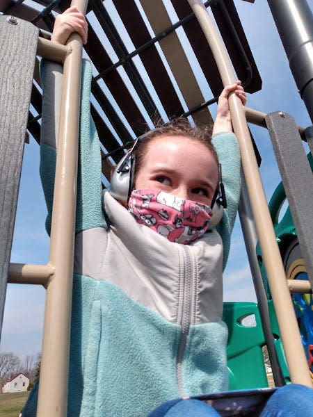 Isla Zielke, a Muskego-Norway fourth grader, wears her mask on the playground. Some school districts like Muskego-Norway that were already mask optional have now made masks optional on school buses. Other school districts that had previously required masks in school buildings and on school buses have now made masks optional in both.