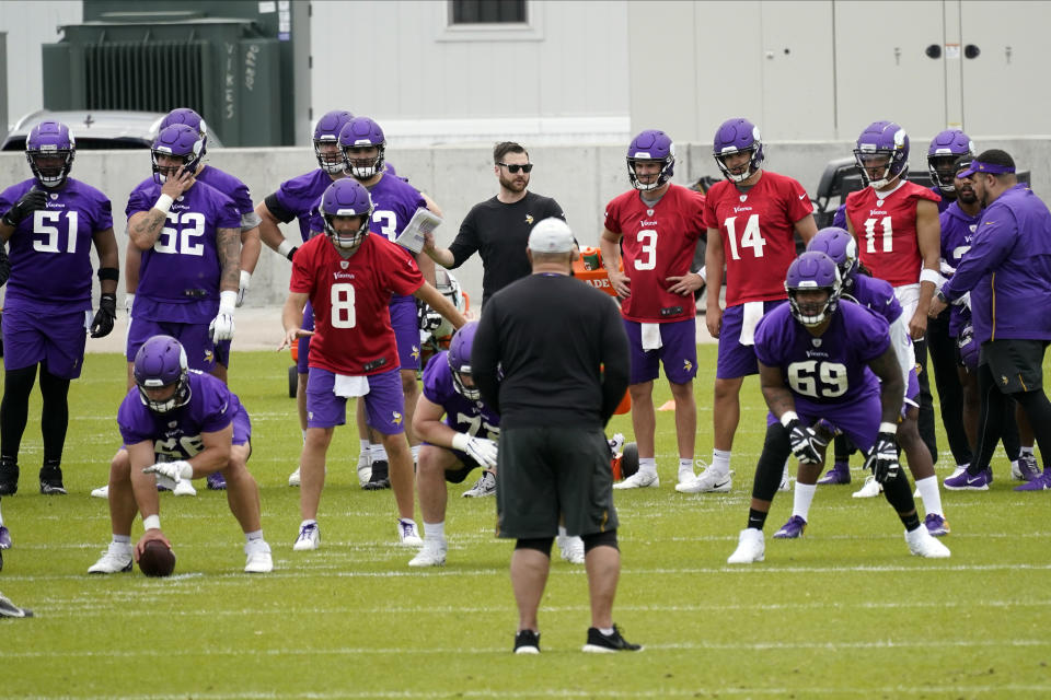 Minnesota Vikings players led by quarterback Kirk Cousins (8) go through offensive drills during NFL football practice in Eagan, Minn., Wednesday, June 2, 2021.(AP Photo/Jim Mone)