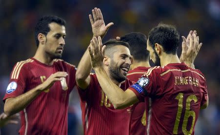 (From L to R) Spain's Sergio Busquets, Jordi Alba and Juanfran Torres celebrate a goal during their Euro 2016 Group C qualification soccer match against Luxembourg in Logrono, Spain October 9, 2015. REUTERS/Vincent West