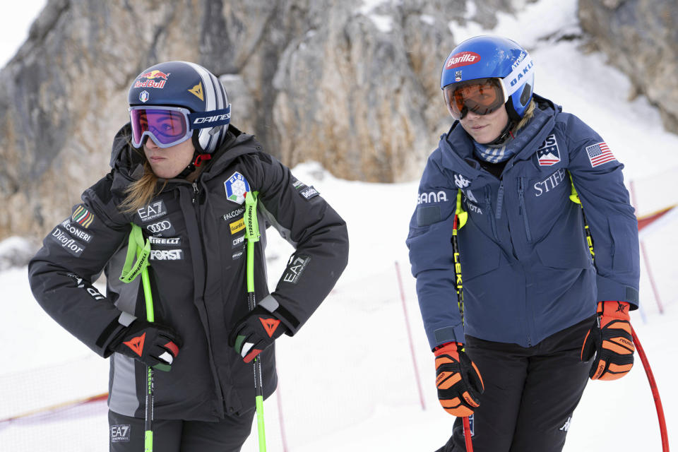 Italy's Sofia Goggia, left, and United States' Mikaela Shiffrin look on during the course inspection of an alpine ski, women's World Cup downhill training, in Cortina d'Ampezzo, Italy, Thursday, Jan. 25, 2024. (AP Photo/Giovanni Zenoni)