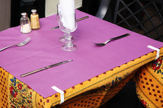 If you like to cover your table with a cloth, make sure you keep it firmly in place by using clip-on table weights.