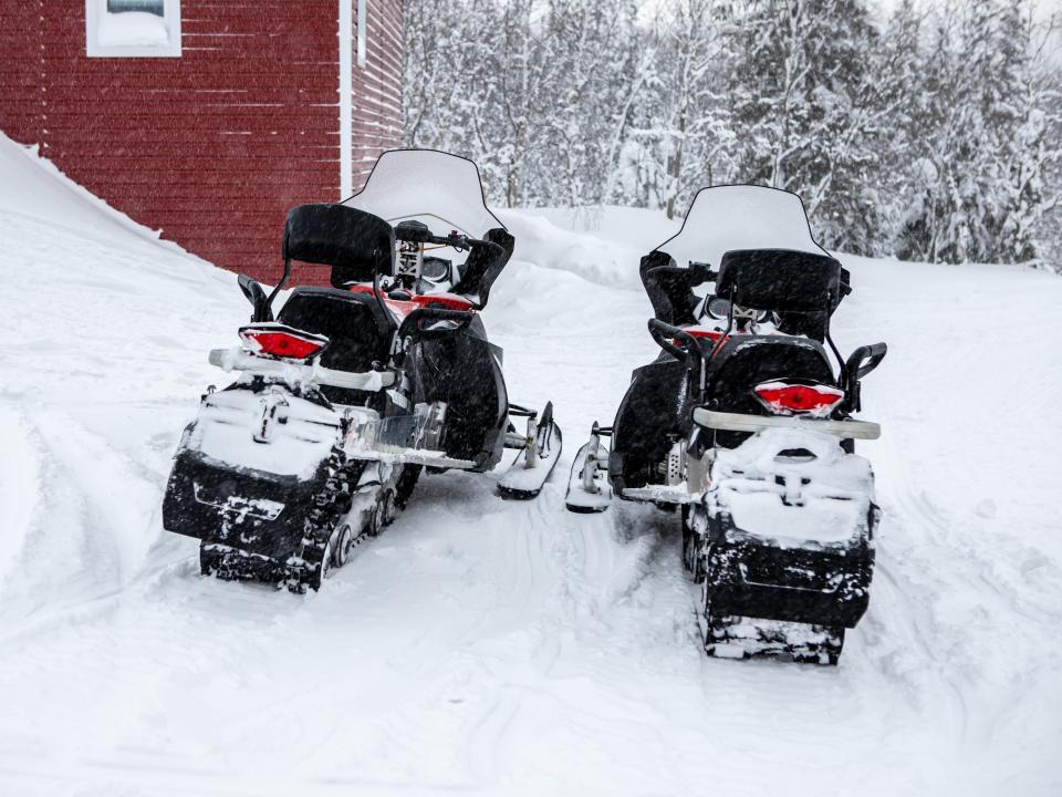 Two red snowmobile in the snow