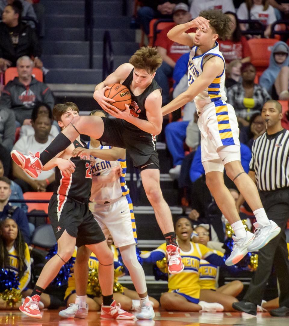 Metamora's Drew Tucker, left, brings down a rebound over Chicago Simeon's Sam Lewis in the overtime period of the Class 3A basketball state title game Saturday, March 11, 2023 at State Farm Center in Champaign. The Redbirds took the title 46-42.