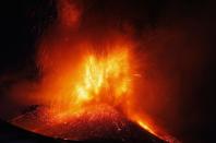 Italy's Mount Etna, Europe's tallest and most active volcano, spews lava as it erupts on the southern island of Sicily November 17, 2013. There were no reports of damage or evacuations in the area and the nearby airport of Catania was operating as normal, local media reported. It is the 16th time that Etna has erupted in 2013. The south-eastern crater, formed in 1971, has been the most active in recent years. REUTERS/Antonio Parrinello (ITALY - Tags: ENVIRONMENT SOCIETY)