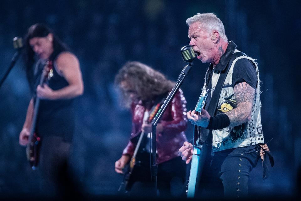 Metallica's James Hetfield performs next to Kirk Hammett and Robert Trujillo during the M72 World Tour at Ford Field in Detroit on Friday, Nov. 10, 2023