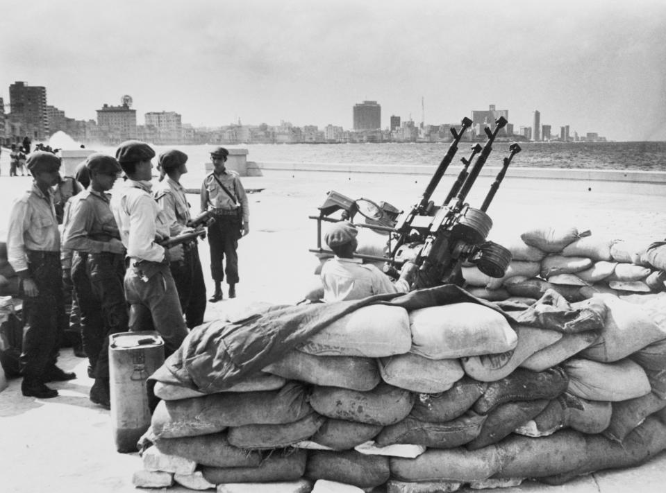 Cuban soldiers stand by an anti-aircraft gun on the Havana waterfront in January 1962, in response to a warning of a U.S. invasion. (Photo: Bettmann Archive via Getty Images)