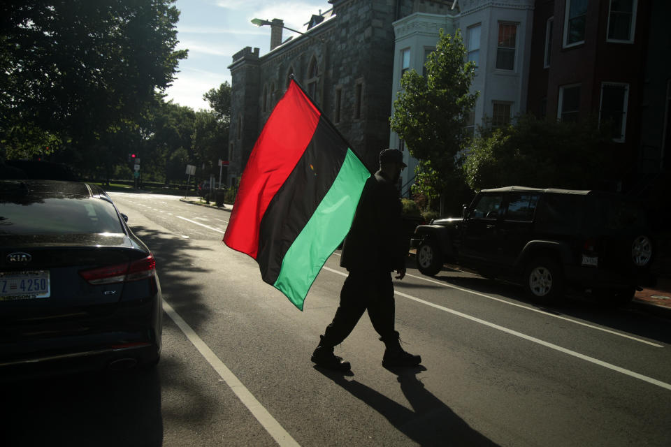 An activist carries a Pan-African flag during a protest to mark the National Reparations Day on Capitol Hill in Washington in 2019.