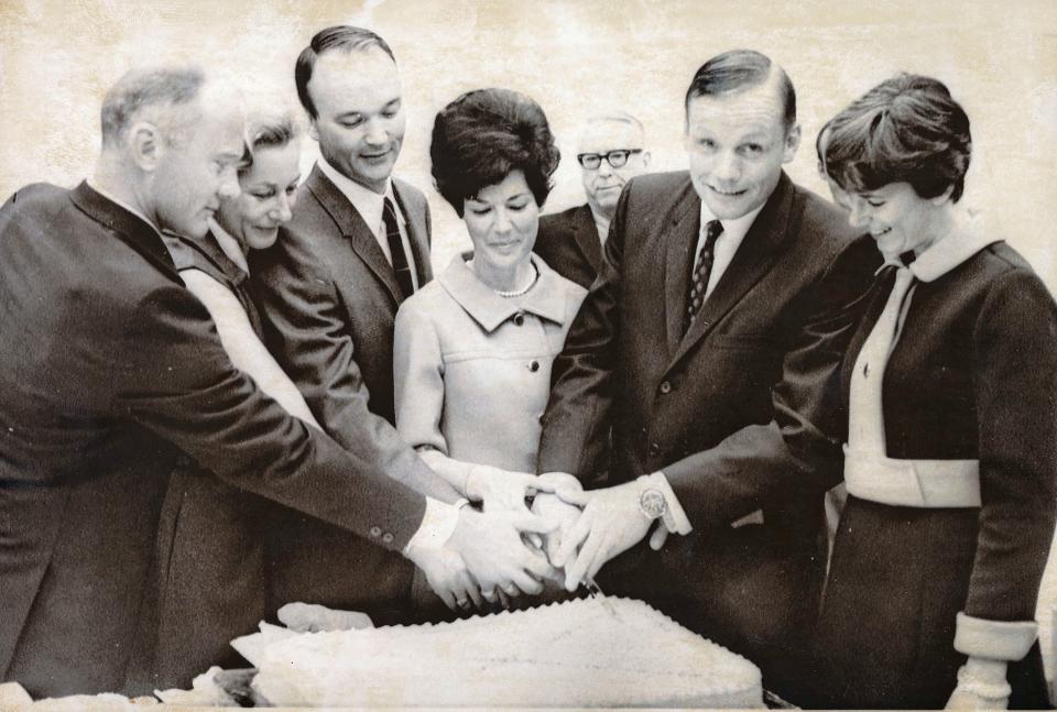 The Apollo 11 crew and their wives cutting a cake at an event in their honor. On the right is Neil Armstong and his wife, Janet; along with Buzz and Joan Aldrin and Michael and Pat Collins.