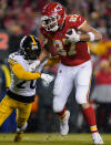 Kansas City Chiefs tight end Travis Kelce (87) tries to break a tackle by Pittsburgh Steelers cornerback Cameron Sutton (20) after catching a pass during the first half of an NFL wild-card playoff football game, Sunday, Jan. 16, 2022, in Kansas City, Mo. (AP Photo/Ed Zurga)