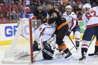 Philadelphia Flyers right wing Jakub Voracek (93), of the Czech Republic, collides with Washington Capitals goaltender Braden Holtby (70) during the second period of an NHL hockey game, Sunday, March 24, 2019, in Washington. Capitals left wing Carl Hagelin (62) and defenseman Brooks Orpik (44) look on. (AP Photo/Nick Wass)