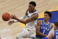 Pittsburgh's Au'diese Toney, left, passes after getting by Duke's Jalen Johnson (1) during the first half of an NCAA college basketball game, Tuesday, Jan. 19, 2021, in Pittsburgh. (AP Photo/Keith Srakocic)