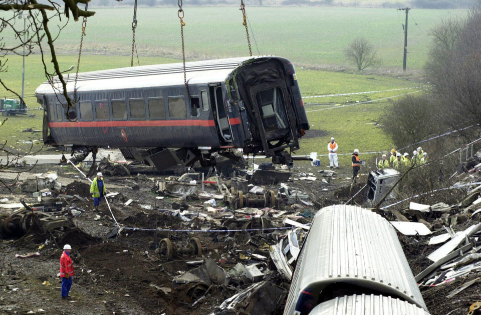 Coach D of the GNER train is moved by crane from the side of the tracks near the village of Great Heck in Yorkshire, following the train crash on 28/02/01.   (Photo by Matthew Fearn - PA Images/PA Images via Getty Images)