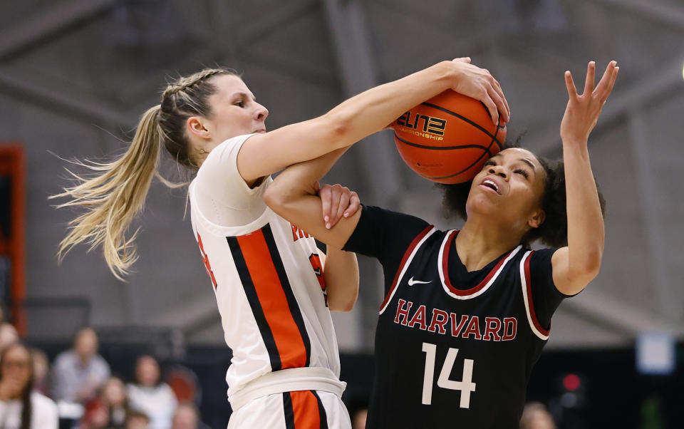 Princeton guard Julia Cunningham, left, takes the ball from Harvard guard Harmoni Turner (14) during the first half of the Ivy League championship NCAA college basketball game, Saturday, March 11, 2023, in Princeton, N.J. (AP Photo/Noah K. Murray)