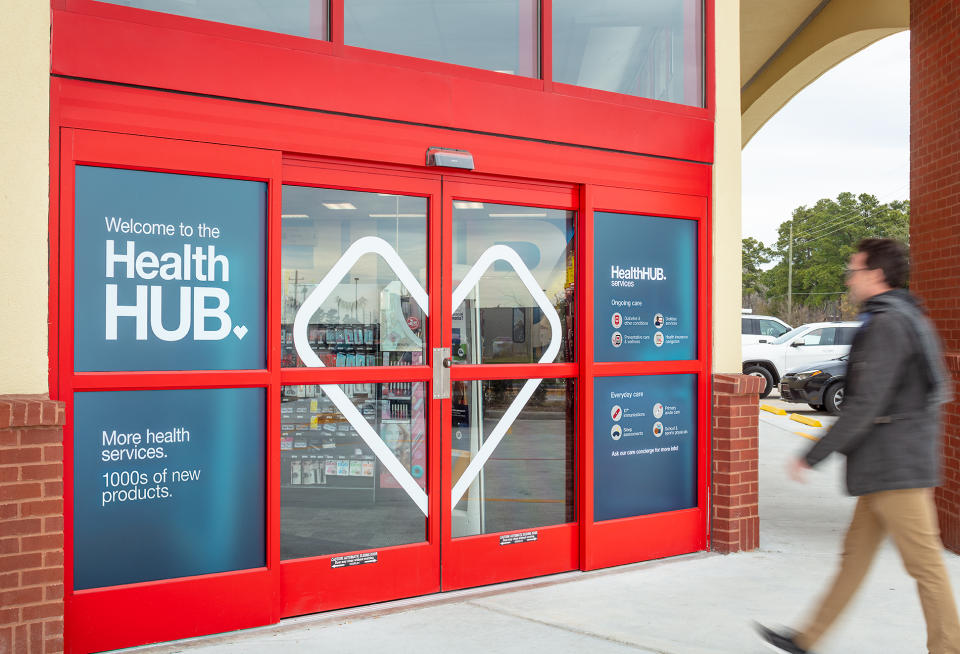 A man walks toward a CVS HealthHub location.