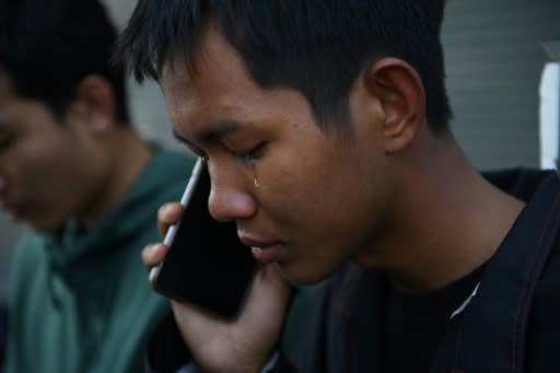 A tear falls from the eye of Weerapat Ketsunthia as he talks on the phone and mourns his friend Atiwat Promsuk, who was killed in a mass shooting at the Terminal 21 shopping mall in Nakhon Ratchasima, Thailand