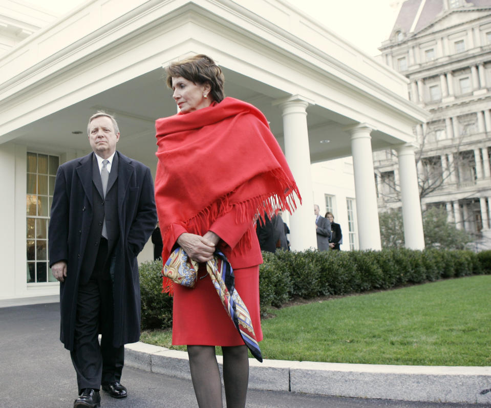 FILE - House Speaker Nancy Pelosi of Calif., right, and Senate Majority Whip Richard Durbin of Ill., walk out of the West Wing of the White House in Washington, Jan. 10, 2007, toward reporters following a meeting with President Bush to discuss his revised Iraq strategy. (AP Photo/Charles Dharapak, File)