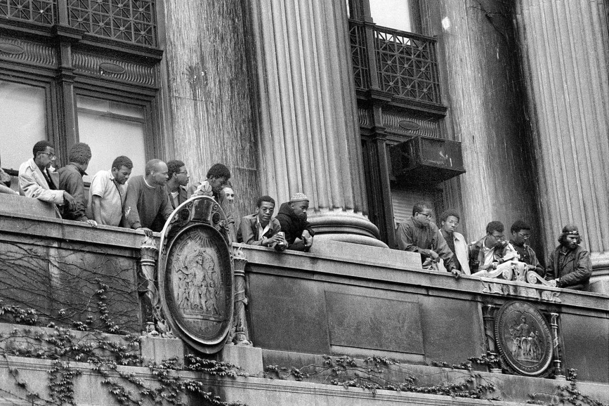 African American students look down on the balcony of Hamilton Hall  (Gene Kappock / NY Daily News via Getty Images)