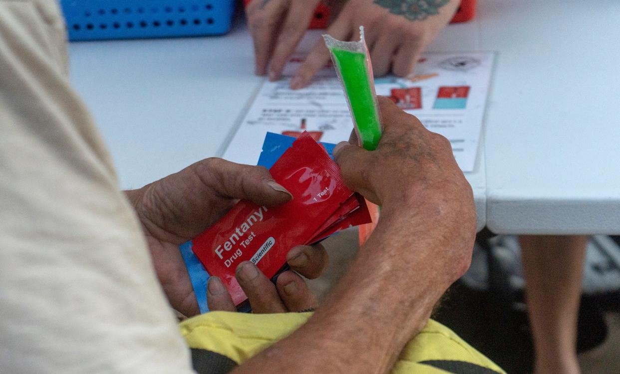 A persson picks up fentanyl and xylazine testing strips at the TN Scientific table near the Savage Sisters Recovery outreach next to McPherson Square in Kensington, Philadelphia on Tuesday, Sept. 5, 2023.
[Daniella Heminghaus]